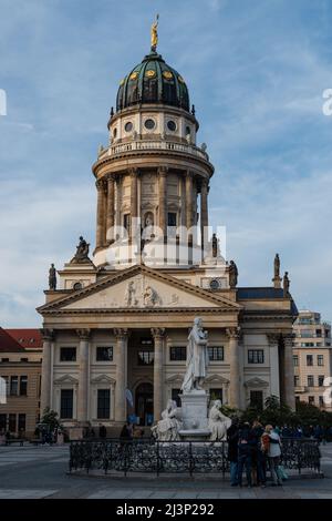 The French Cathedral (Französischer Dom) on Gendarmenmarkt square in Berlin, Germany with a group of tourists Stock Photo