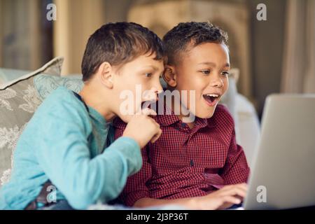 Do you know what your kids are looking at online. Shot of two young boys looking astonished by something on the internet. Stock Photo