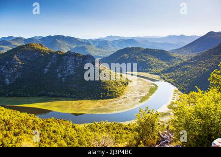 Sinuous river flowing through mountains. Rijeka Crnojevica. Located near Skadar Lake, Montenegro, Europe. Beauty world. Stock Photo