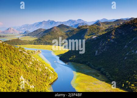 Sinuous river flowing through mountains. Rijeka Crnojevica. Located near Skadar Lake, Montenegro, Europe. Beauty world. Stock Photo