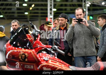 Moscow, Russia. 9th Apr, 2022. A visitor takes pictures of motorcycles during the Motospring exhibition in Moscow, Russia, April 9, 2022. Credit: Alexander Zemlianichenko Jr/Xinhua/Alamy Live News Stock Photo