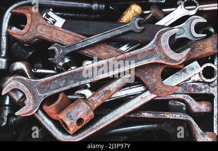 Toolbox of different dirty old hand tools at garage. Top view Stock Photo