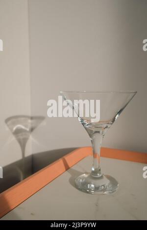 empty martini glass on stylish background in modern color. Stock Photo