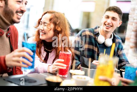 Young people on genuine laugh moment at fancy pub restaurant outside - Life style concept with trendy friends sharing happy hour time together Stock Photo