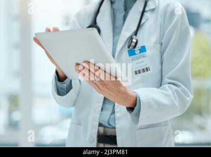 Where is she. Shot of an unrecognizable doctor using a digital tablet at work. Stock Photo