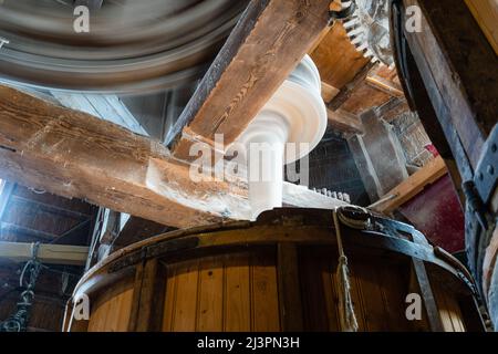 Weesp, Netherlands. 09 apr 2022. Rotating cog-wheels and mill-stones make the fine flour dust light up  inside the working windmill 'de Vriendschap'.  The Guild of Voluntary Millers will be 50 years old in 2022.  To underline the importance of the miller's craft , a record attempt was made to have all Dutch rotating wind and water turbines in the Netherlands run simultaneously between 11:00 and 12:00. More than 800 mills  participated, including 29 mills abroad.  Credit: Steppeland/Alamy Live News Stock Photo