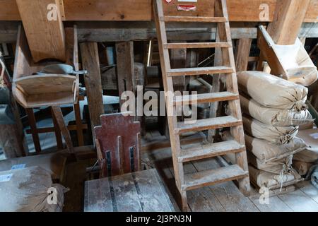 Weesp, Netherlands. 09 apr 2022. Piled up sacs of wheet, a ladder and scooping equipement inside the working windmill 'de Vriendschap'.  The Guild of Voluntary Millers will be 50 years old in 2022.  To underline the importance of the miller's craft , a record attempt was made to have all Dutch rotating wind and water turbines in the Netherlands run simultaneously between 11:00 and 12:00. More than 800 mills  participated, including 29 mills abroad.  Credit: Steppeland/Alamy Live News Stock Photo