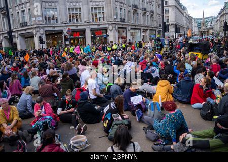 Oxford Street, London, UK. 9th Apr, 2022. Extinction Rebellion protesters are gathering in London ahead of a period of civil resistance actions likely to cause disruption in the City and beyond, in protest against alleged causes of climate change. They have sat down and blocked Oxford Street and marched down Regent Street. Stock Photo