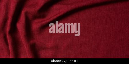 Red crumpled linen fabric texture background. Natural linen organic eco textiles canvas background. Top view Stock Photo