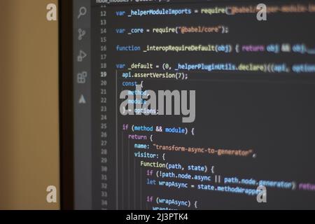 Javascript programming with code editor. Code development with a laptop Stock Photo