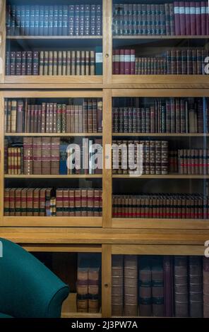 Vintage bookcase with bound books Stock Photo