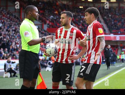Sheffield, England, 9th April 2022.   George Baldock of Sheffield Utd and Morgan Gibbs-White of Sheffield Utd questions s to why the assistant referee didn’t see the foul in the area on Gibbs-White during the Sky Bet Championship match at Bramall Lane, Sheffield. Picture credit should read: Simon Bellis / Sportimage Stock Photo