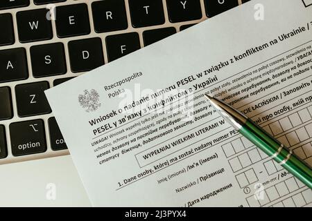 PESEL document, Ukrainian passport and a pen on white table background. Stock Photo