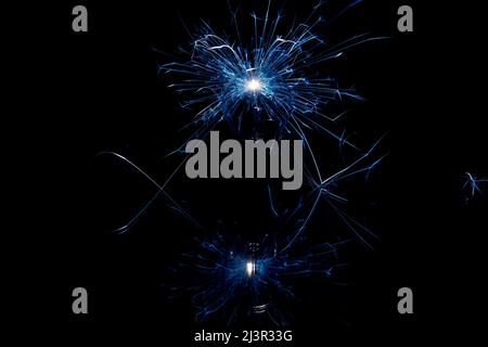 Incandescent lamp with sparks on a black background. Stock Photo
