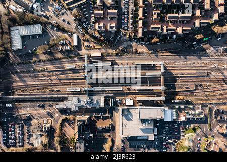 A top down aerial view of The tracks and platforms of Peterborough train station and surrounding city area Stock Photo
