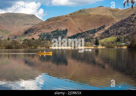 Tourists in a rowing boat on Grasmere lake in The Lake District National Park Stock Photo