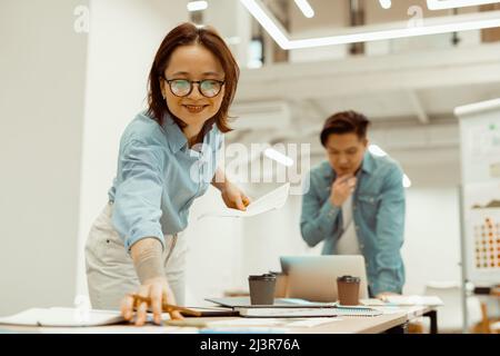 Two people are busy with a new project in a co-working space Stock Photo