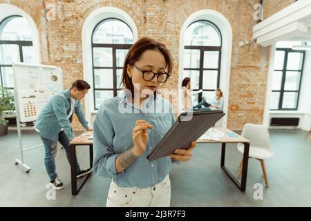 Portrait of businesswoman with tablet in office Stock Photo