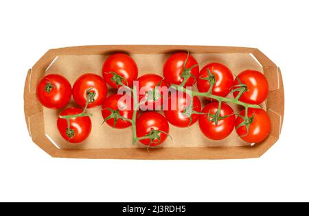 Vine of cherry tomatoes, in a cardboard tray. Ripe, small, round, red cocktail tomatoes in the size of a thumb tip, with sweet taste. Stock Photo