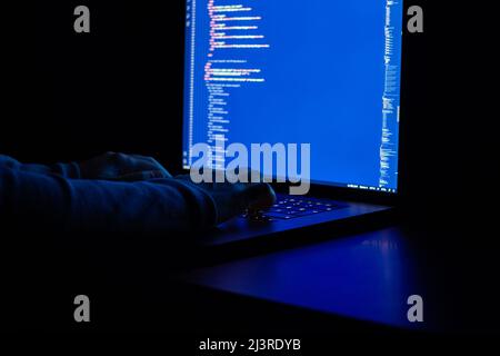 Working at night, the developer is doing web programming with javascript. Close-up hand and computer Stock Photo