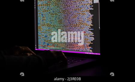 Software developer develops web programming at night. Stock Photo