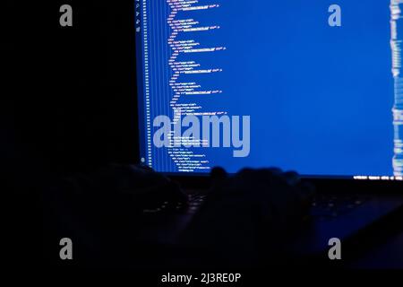 Working at night, the developer is doing web programming with javascript. Close-up hand and computer Stock Photo