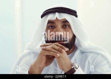 At my best when Im in my office. Cropped portrait of a young businessman dressed in Islamic traditional clothing working in his office. Stock Photo