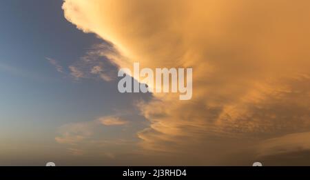 Contrasting red clouds against a blue sky  Stock Photo