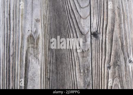 Grey wood planks texture background. Real wood grain backdrop with natural lines in the timber. Weathered flooring pattern as an abstract design. Stock Photo