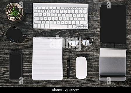 Wireless makes business work. High angle shot of a variety of wireless devices on a work desk. Stock Photo