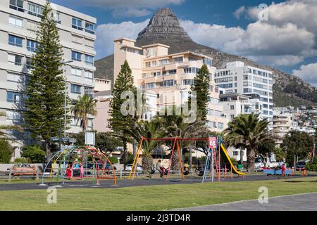 South Africa, Cape Town.  Children's Playground on the  Sea Point Promenade.  Lion's Head in the background. Stock Photo