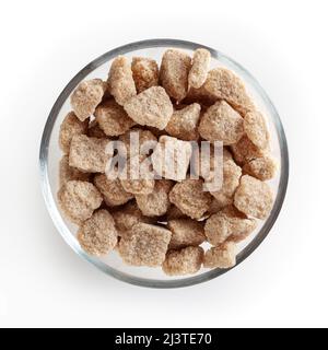 Cubes of brow cane sugar in glass bowl isolated on white background with clipping path Stock Photo