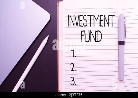 Sign displaying Investment Fund. Word Written on A supply of capital belonging to numerous investors Office Supplies Over Desk With Keyboard And Stock Photo