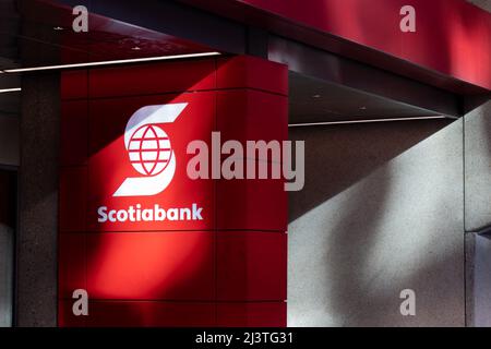 The Scotiabank logo is seen in the sun outside of a bank branch in downtown Toronto. Stock Photo