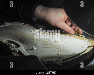 luthier working on a new violin in his workshop Stock Photo