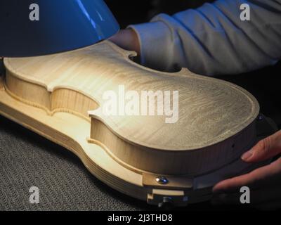 luthier working on a new violin in his workshop Stock Photo