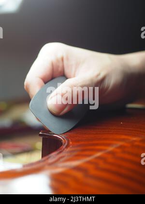 luthier working on a new violin in his workshop Stock Photo