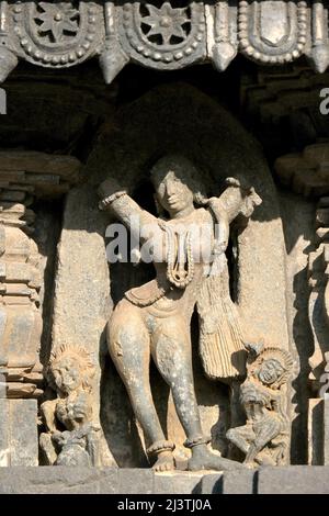 Stone Sculpture of Beautiful Female (Madanikas) with selective focus, 12th century Hindu temple, Ancient stone art and sculptures in each pillars, Che Stock Photo