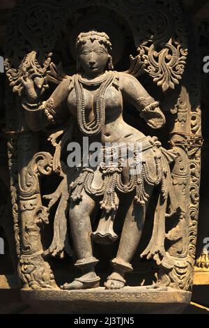 Stone Sculpture of Beautiful Female (Madanikas) with selective focus, 12th century Hindu temple, Ancient stone art and sculptures in each pillars, Che Stock Photo