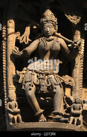 Stone Sculpture of Beautiful Female (Madanikas) with selective focus, 12th century Hindu temple, Ancient stone art and sculptures in each pillars, Che Stock Photo