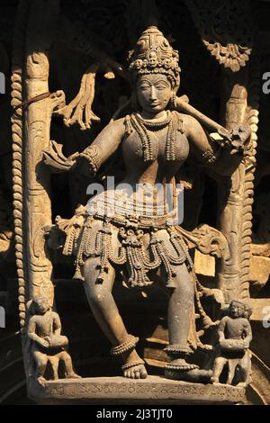 Stone Sculpture of Beautiful Female (Madanikas) with selective focus, 12th century Hindu temple, Ancient stone art and sculptures in each pillars, Che Stock Photo