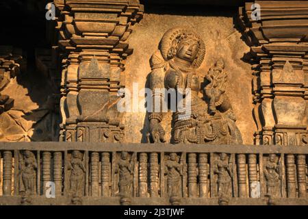 Stone Sculpture of Beautiful Female (Madanikas) with selective focus, 12th century Hindu temple, Ancient stone art and sculptures in each pillars, Che Stock Photo