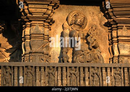 Stone Sculpture of Beautiful Female (Madanikas) with selective focus, 12th century Hindu temple, Ancient stone art and sculptures in each pillars, Che Stock Photo