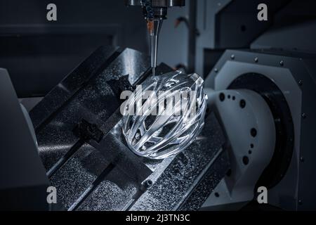 Metalworking CNC milling machine. Cutting metal modern processing technology. Small depth of field. Warning - authentic shooting in challenging condit Stock Photo
