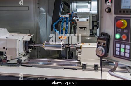 Metalworking CNC milling machine. Cutting metal modern processing technology. Small depth of field. Warning - authentic shooting in challenging condit Stock Photo
