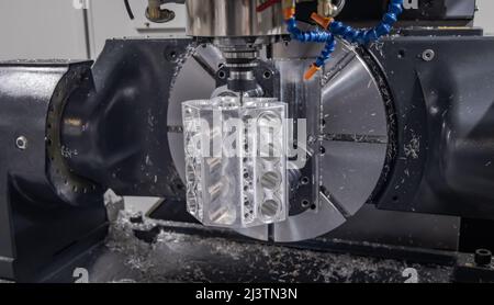 Metalworking CNC milling machine. Cutting metal modern processing technology. Small depth of field. Warning - authentic shooting in challenging condit Stock Photo