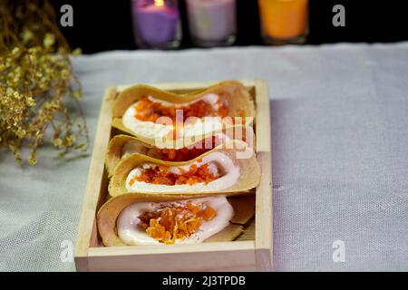 Crispy pancake on wooden tray Stock Photo