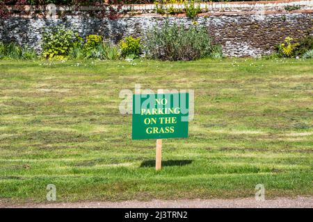 A No Parking on the Grass sign in an English village. Stock Photo