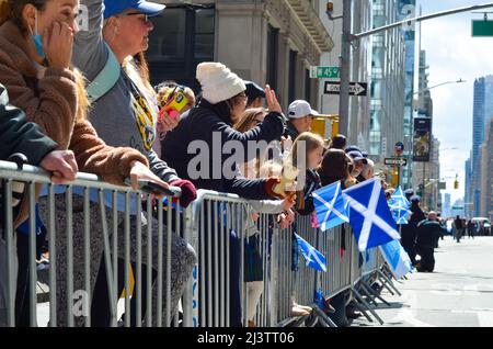 New York, United States. 09th Apr, 2022. People are seen holding Scottish flag during the world's largest pipe and drum parade to celebrate Scottish Tartan Day on April 9, 2022 in New York City. (Photo by Ryan Rahman/Pacific Press) Credit: Pacific Press Media Production Corp./Alamy Live News Stock Photo