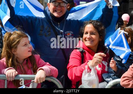People are seen holding Scottish flag during the world's largest pipe and drum parade to celebrate Scottish Tartan Day on April 9, 2022 in New York City. (Photo by Ryan Rahman/Pacific Press) Stock Photo